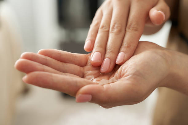 White hands with massage oil ready to apply with fingers