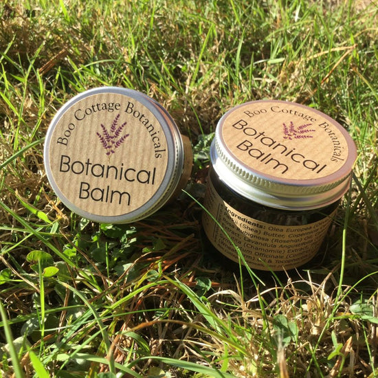 2 pots of Botanical Balm in grass