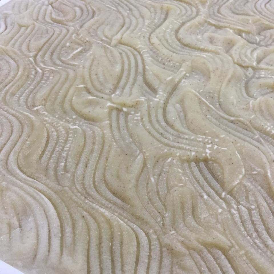 Cream slab of soap showing the texture on top made by a swirled fork