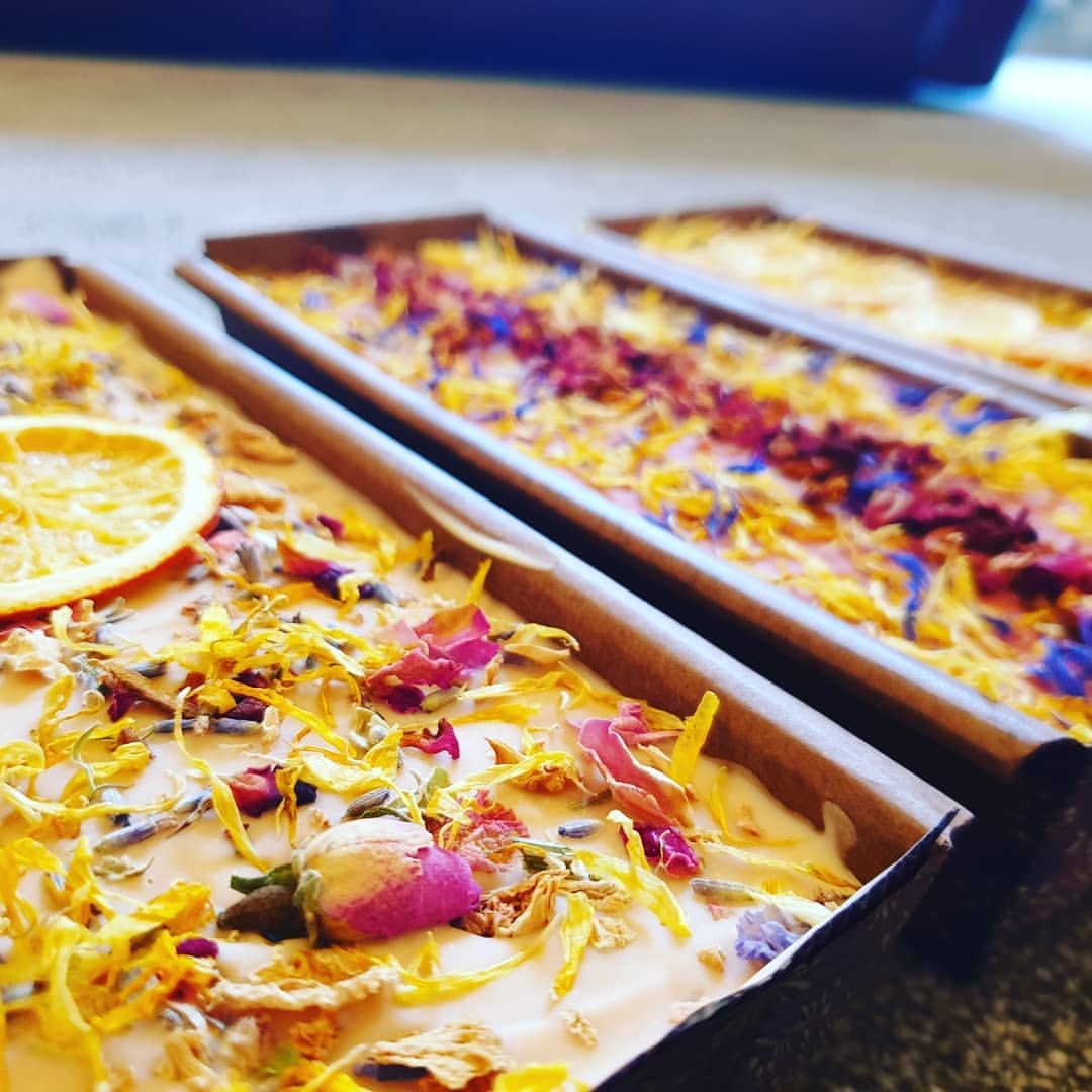 Soaps in mould with calendula petals and rose buds on top