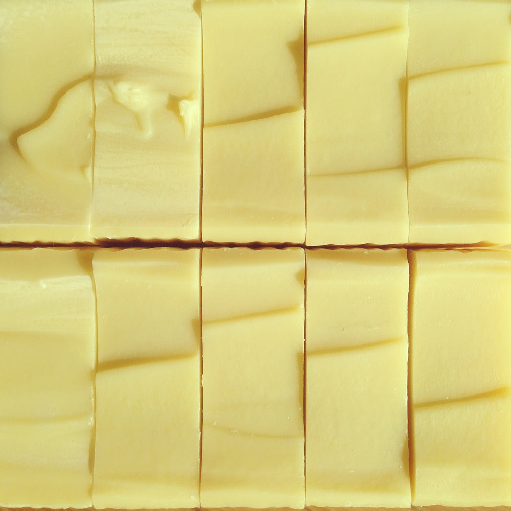 Collection of cream bars of soap with smooth tops all uniform next to each other