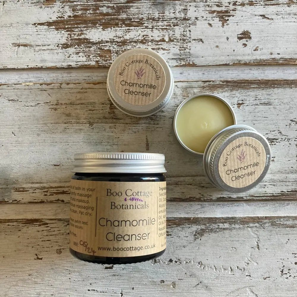 Cleanser in jar with mini sample sized tins on white background