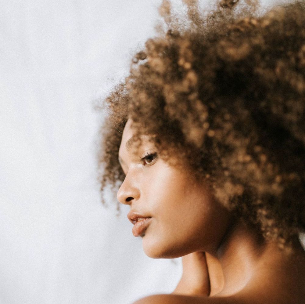 Afro haired female on white background