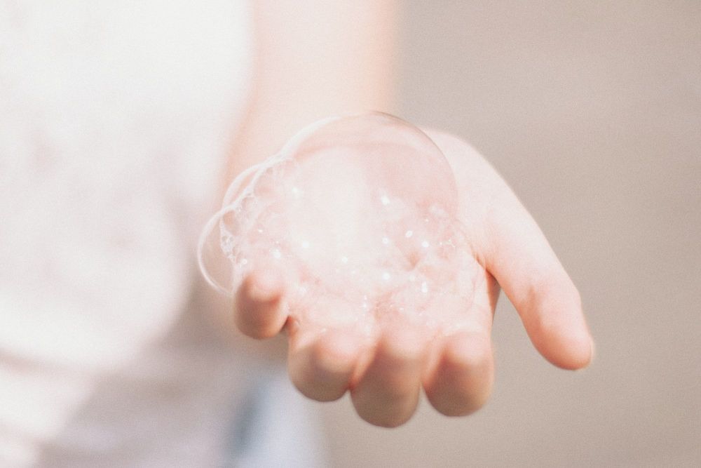 Soap bubble in hand