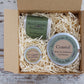Coastal themed lotion bar in tin, green soap and lip balm in brown card gift box with shredded cream paper
