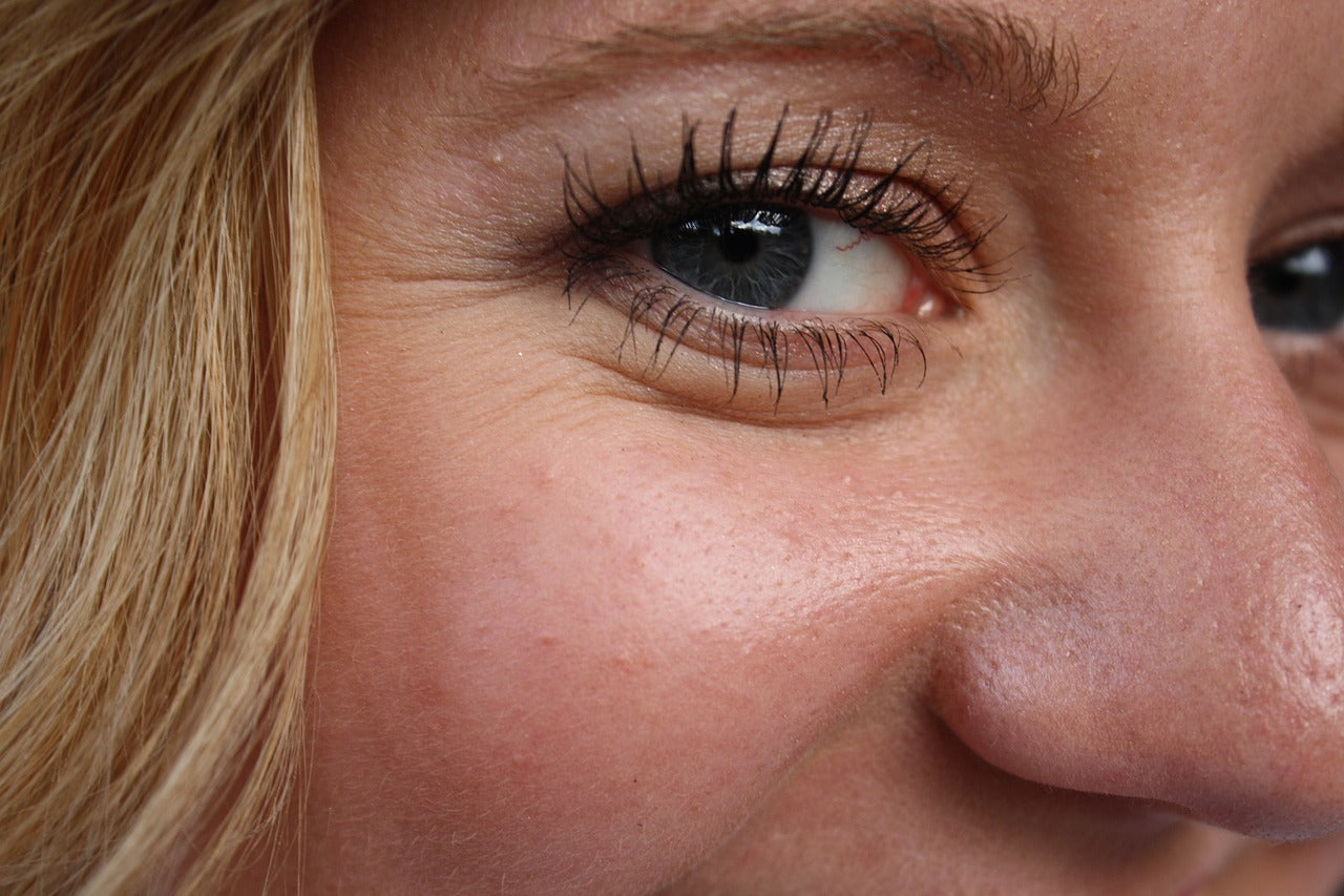 Close up of eye and face of blonde female