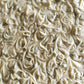 Pale green slab of soap with swirly texture