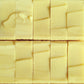 Collection of cream bars of soap with smooth tops all uniform next to each other
