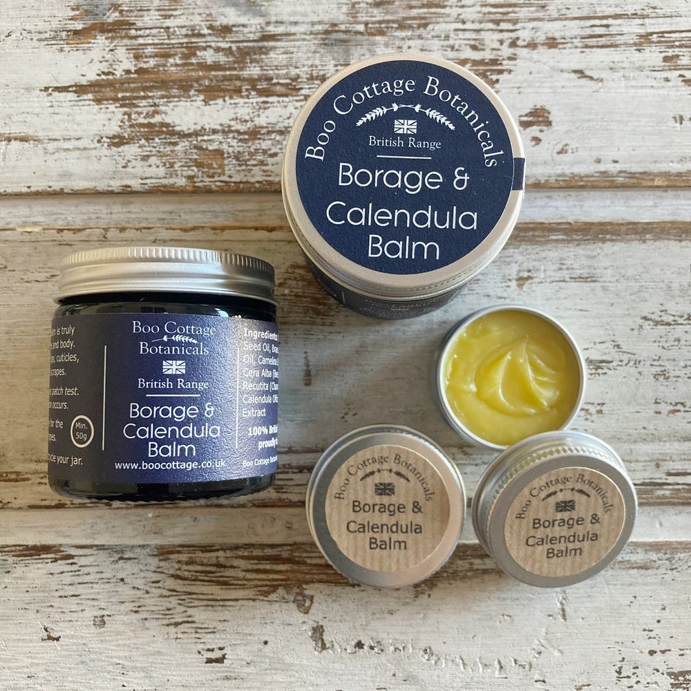 Amber jar with blue label and aluminium lid of Borage & Calendula Balm alongside mini sample tins on white background