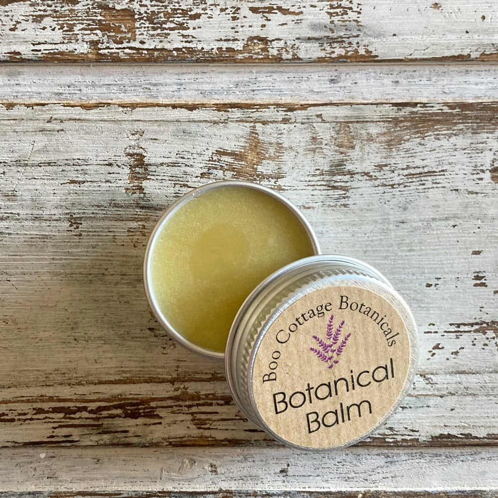 Cream coloured sample of Botanical Balm in mini aluminium tin on white background